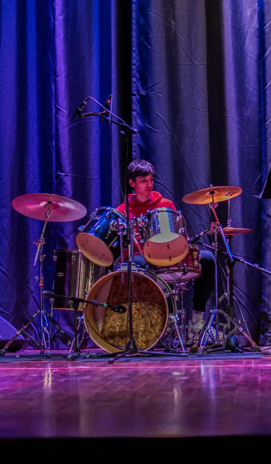 Kabir playing drums on stage